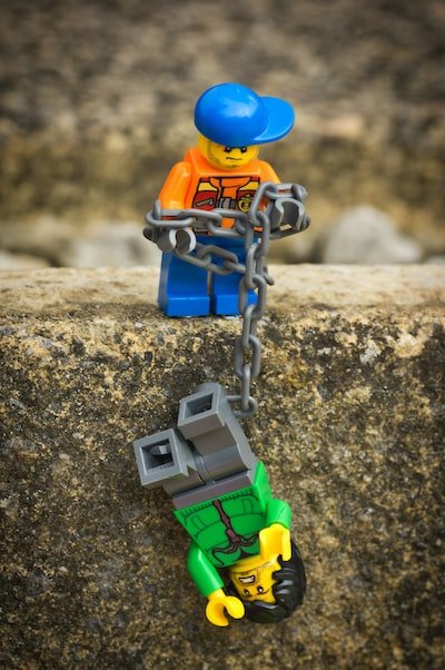 A Lego figure with a chain saving another Lego figure by pulling him up the side of the mountain - An anxiety disorder could save your life.