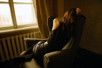 woman turned around in her chair seemingly depressed - Depressed State Of Mind